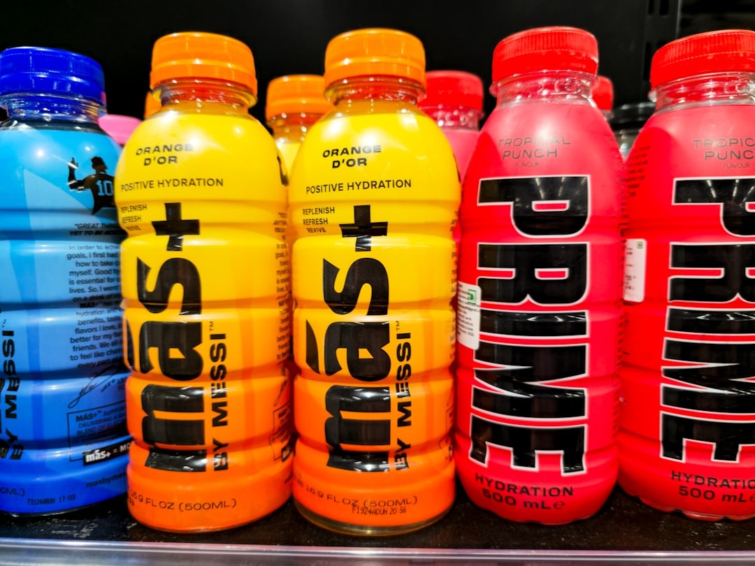 Hydration drink bottles with branded labels sit on a shelf.